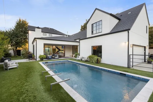 a view of a house with swimming pool and sitting area