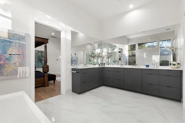 a bathroom with a tub sink shower and mirror