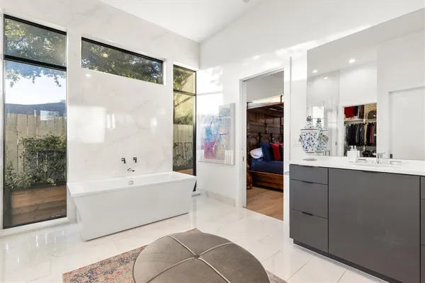 a bed sitting in a bedroom next to a window