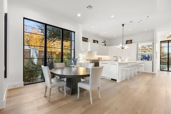 a living room with furniture a flat screen tv and a table
