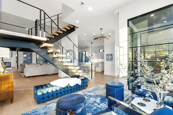 a living room with furniture and a chandelier