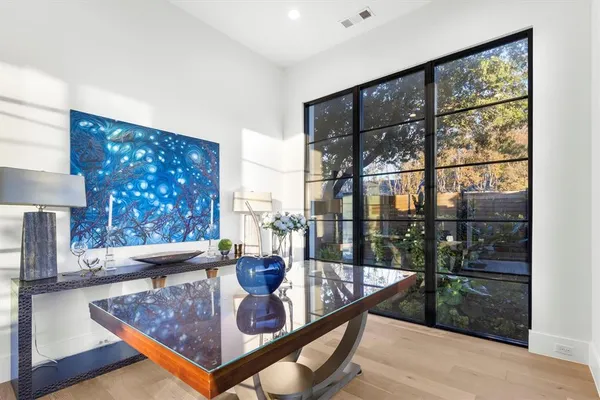 a living room with furniture and a floor to ceiling window