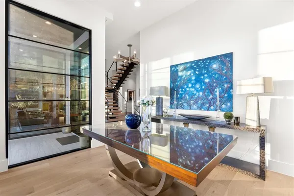 a living room with a pool table and a large window