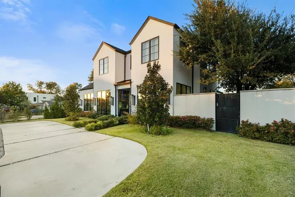 a view of a house with a yard and tree s