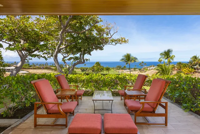 a living room with furniture and a ceiling fan