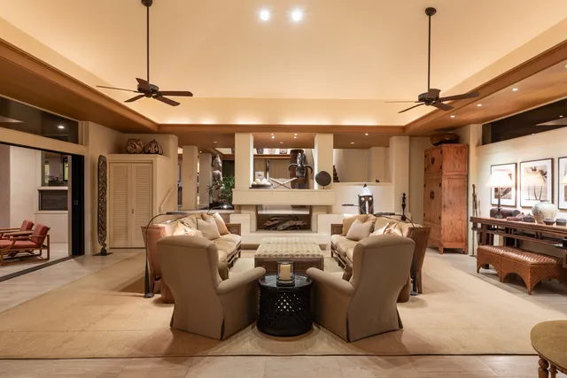 a living room with furniture and a ceiling fan