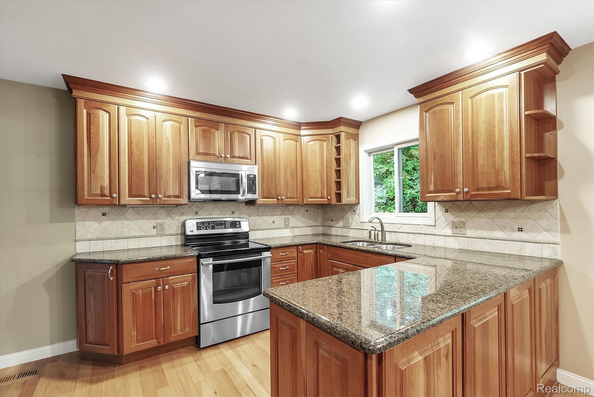 3335 Jewell Road Howell, MI 48843 - Photo 13 of 32 13-Electric stove and microwave are included.