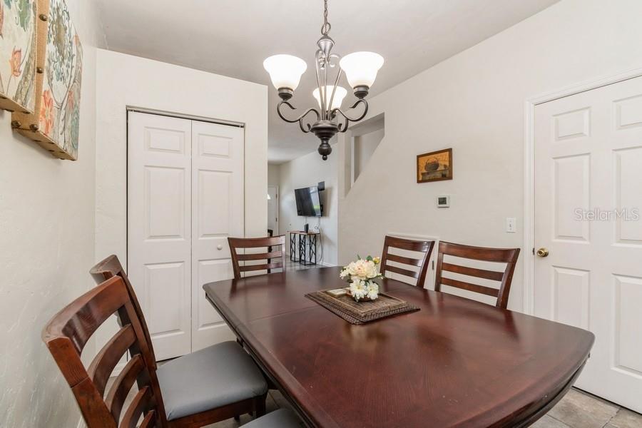 4415 Southwest 34th Street, Unit 204 Gainesville, FL 32608 - Photo 14 of 33 a view of a dining room with furniture and chandelier