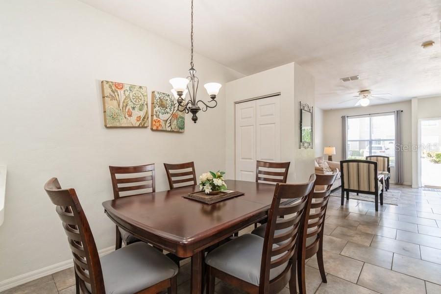 4415 Southwest 34th Street, Unit 204 Gainesville, FL 32608 - Photo 15 of 33 a view of a dining room with furniture a chandelier and wooden floor