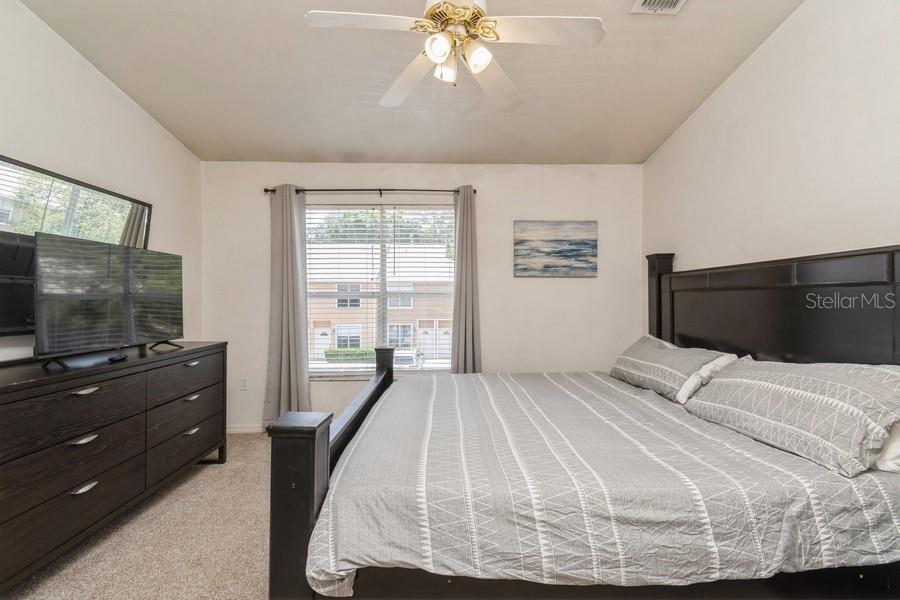 4415 Southwest 34th Street, Unit 204 Gainesville, FL 32608 - Photo 18 of 33 a bedroom with a bed and a flat screen tv