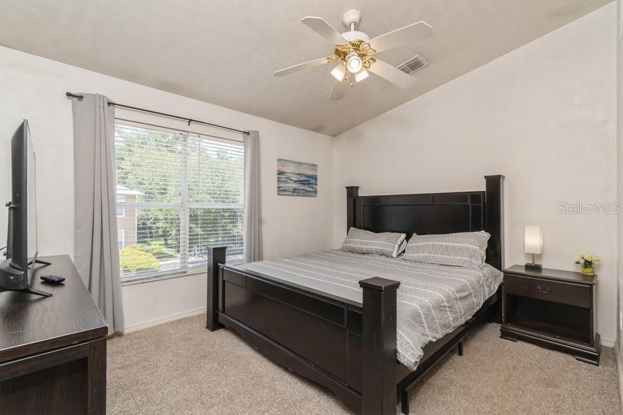 4415 Southwest 34th Street, Unit 204 Gainesville, FL 32608 - Photo 19 of 33 a bedroom with a bed and a chandelier