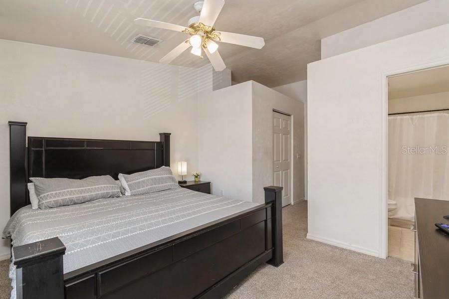 4415 Southwest 34th Street, Unit 204 Gainesville, FL 32608 - Photo 20 of 33 a bedroom with a bed and a chandelier