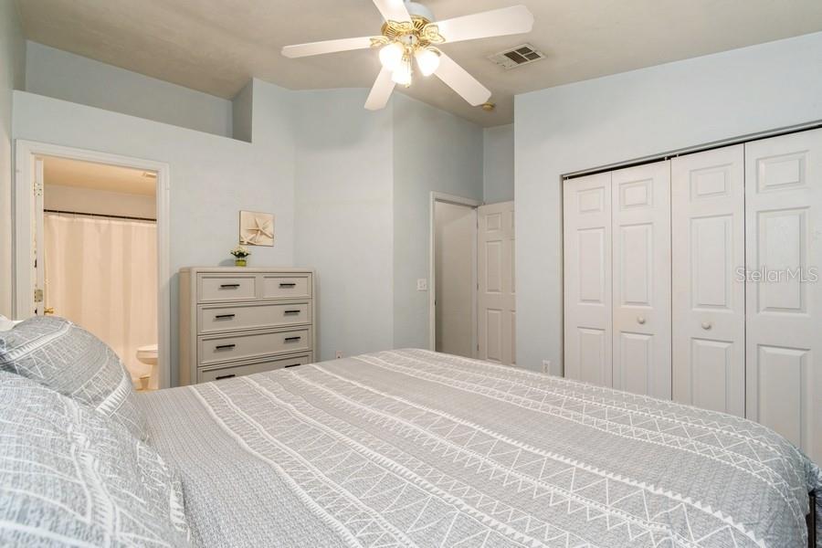 4415 Southwest 34th Street, Unit 204 Gainesville, FL 32608 - Photo 24 of 33 a bedroom with a large bed and a chandelier