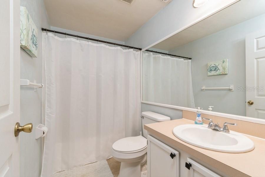 4415 Southwest 34th Street, Unit 204 Gainesville, FL 32608 - Photo 25 of 33 a bathroom with a toilet sink and mirror
