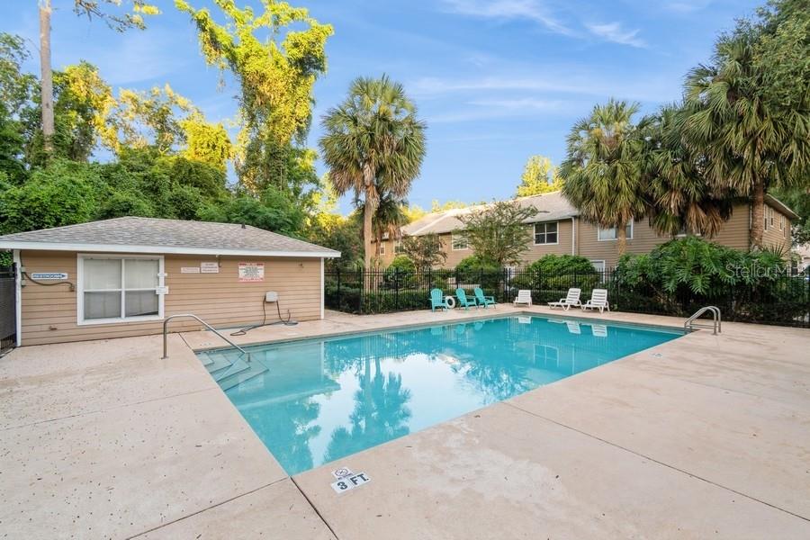 4415 Southwest 34th Street, Unit 204 Gainesville, FL 32608 - Photo 31 of 33 a view of a house with a yard and potted plants
