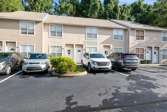 a car parked in front of a white house