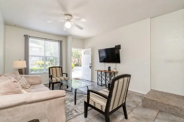 a living room with furniture and a flat screen tv