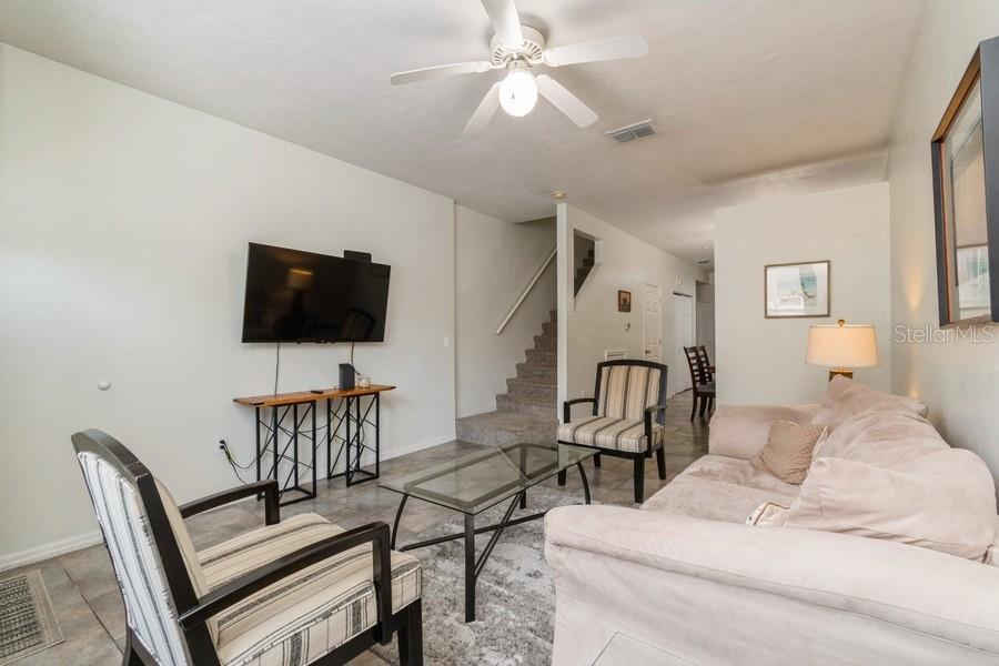 4415 Southwest 34th Street, Unit 204 Gainesville, FL 32608 - Photo 6 of 33 a living room with furniture and a flat screen tv