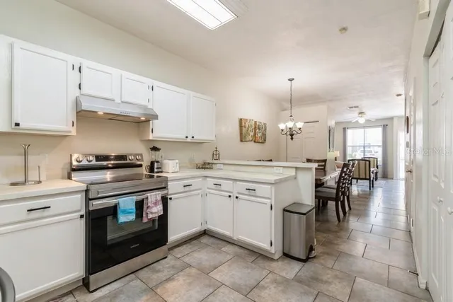 a kitchen with a stove top oven sink and cabinets