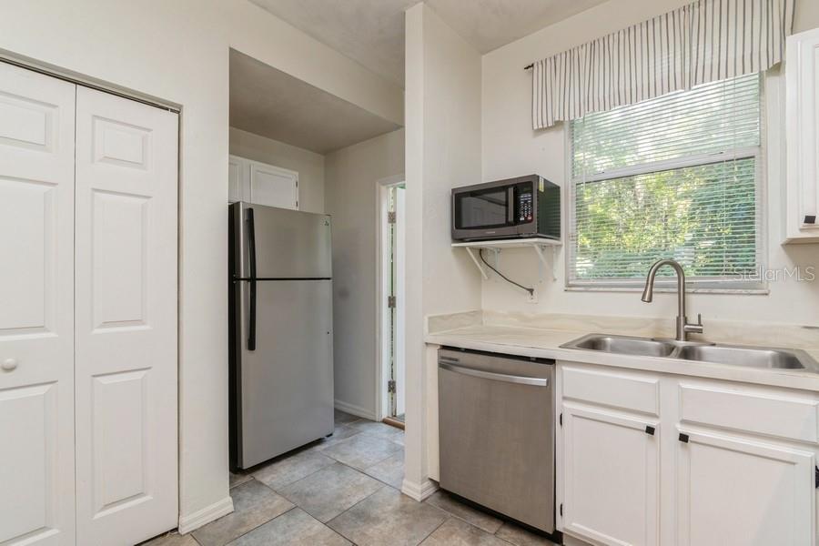 4415 Southwest 34th Street, Unit 204 Gainesville, FL 32608 - Photo 9 of 33 a kitchen with a refrigerator sink and cabinets