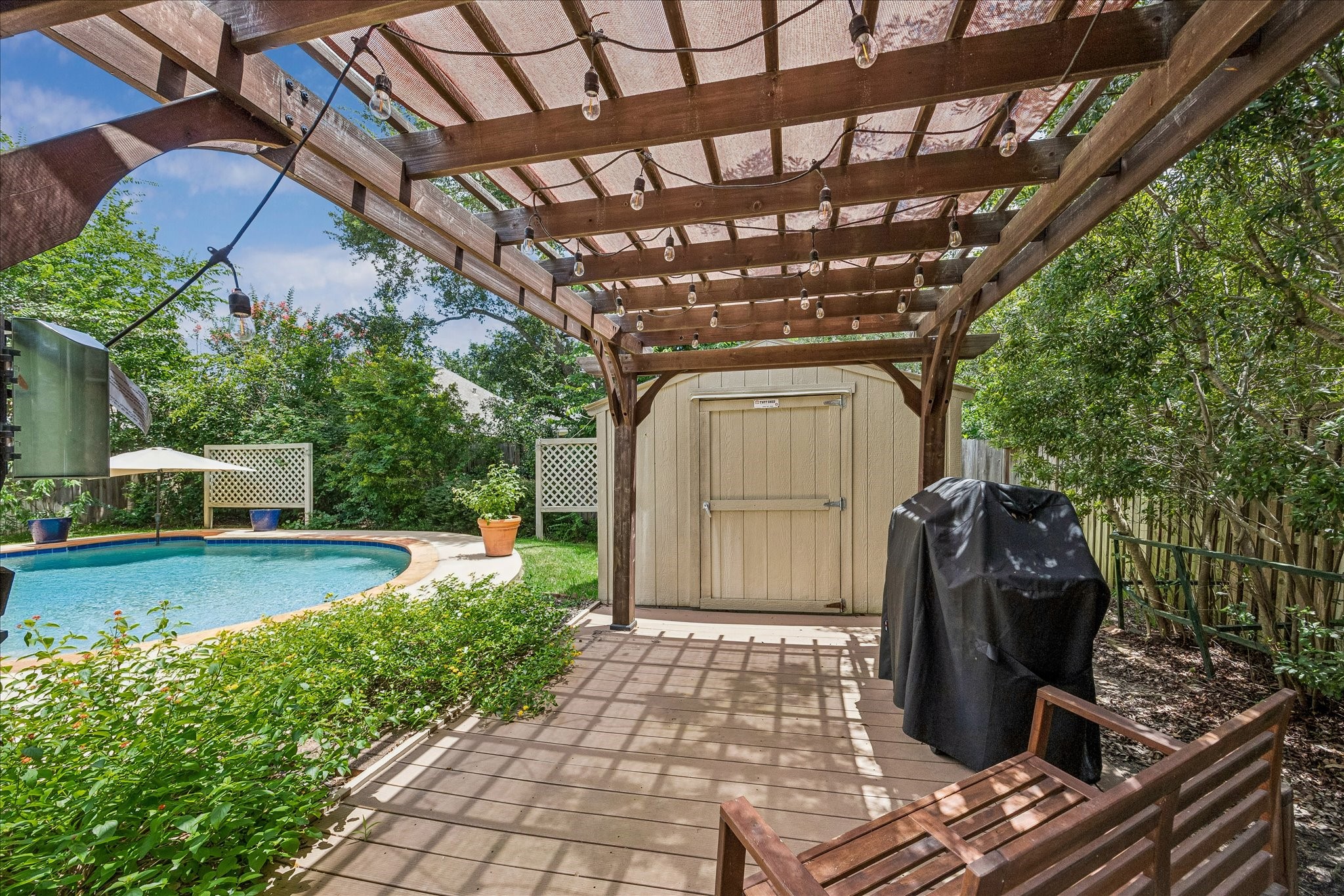 5811 Walkabout Way Katy, TX 77450 - Photo 27 of 33 Enjoy shaded poolside lounging beneath the pergola while taking in views of the backyard retreat.