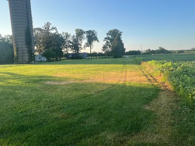a view of a yard with a lake view