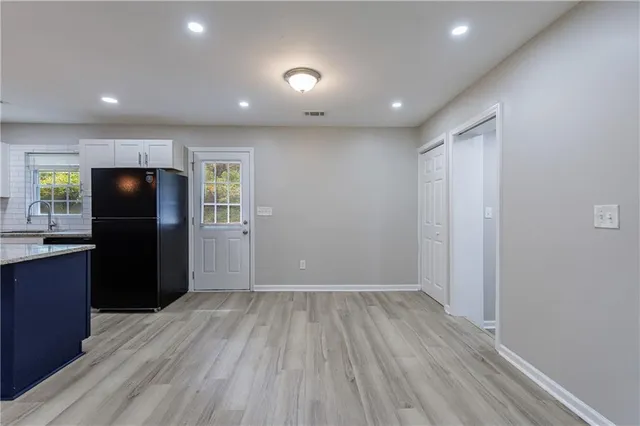 a kitchen with stainless steel appliances granite countertop a refrigerator stove and microwave