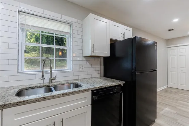 a kitchen with a sink a counter space and a window