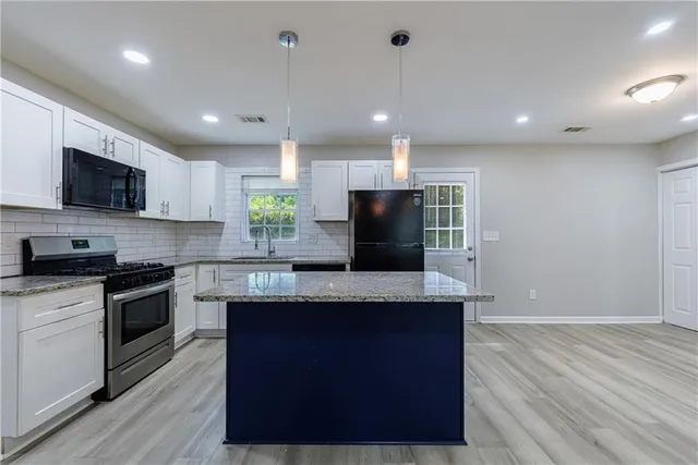 an empty room with a window and ceiling fan
