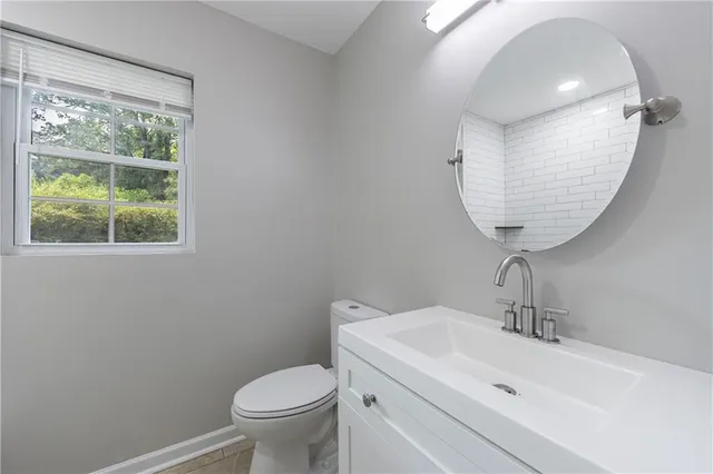 a bathroom with a granite countertop sink mirror and vanity