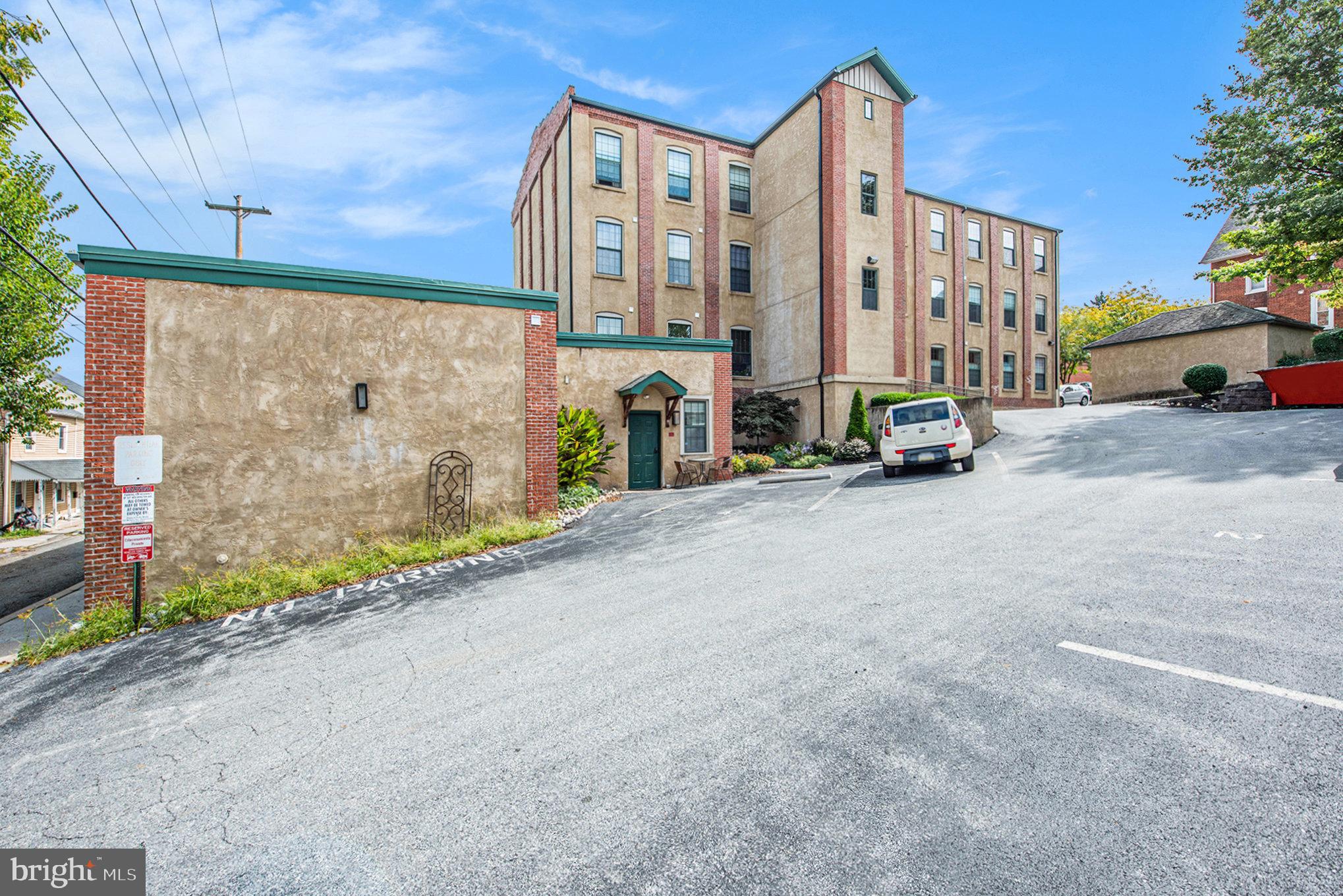 541 Washington Avenue, Unit 101 Phoenixville, PA 19460 - Photo 2 of 11 a view of a street with a cars parked in front of it