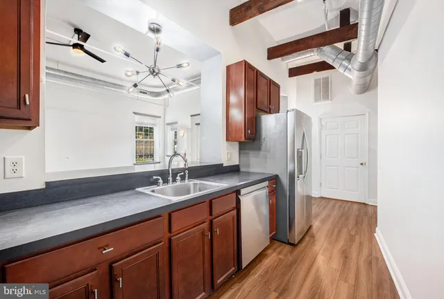 a spacious bathroom with a granite countertop sink a mirror and shower