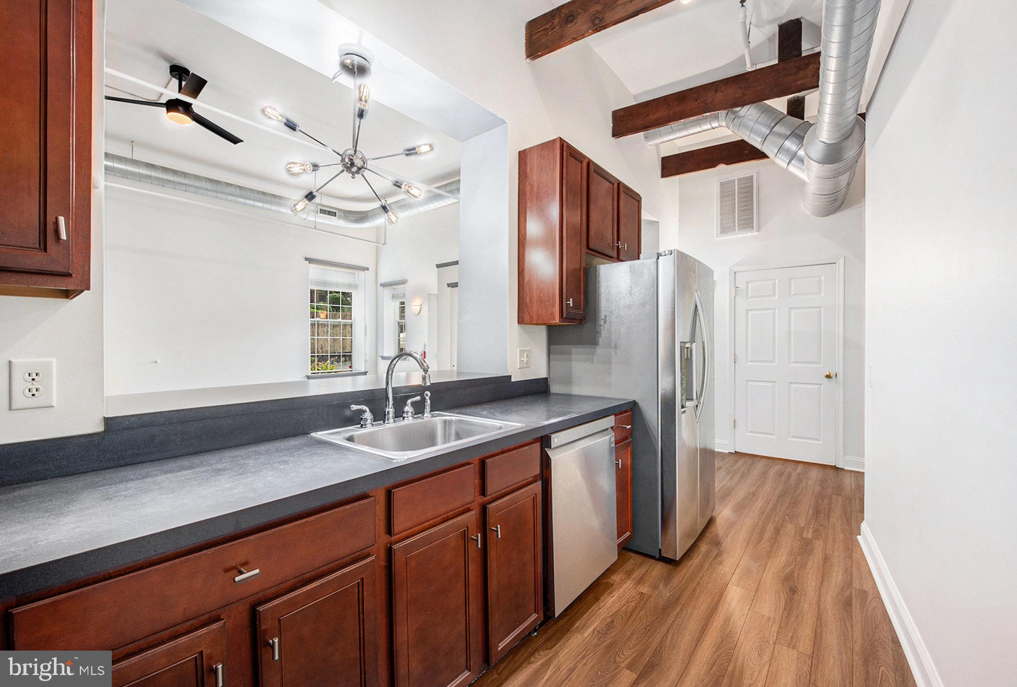 541 Washington Avenue, Unit 101 Phoenixville, PA 19460 - Photo 7 of 11 a spacious bathroom with a granite countertop sink a mirror and shower