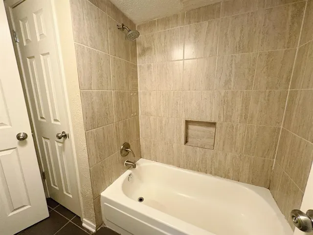 a bathroom with a bathtub and shower