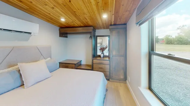 a bedroom with a bed and a night stand