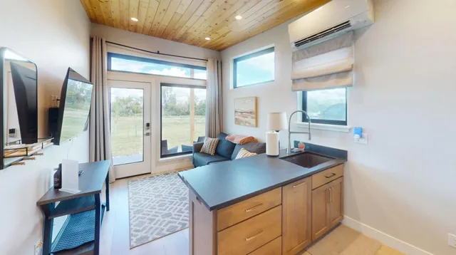 a kitchen with stainless steel appliances granite countertop a sink a stove and a refrigerator