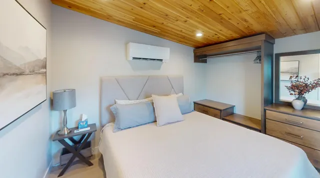 a bedroom with a bed and a dresser