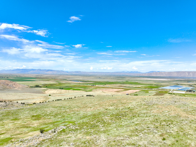 160 Dry Canyon St. Charles, ID 83272 - Photo 60 of 63 Expansive landscape featuring rolling hills and distant mountains under a clear blue sky with scattered clouds