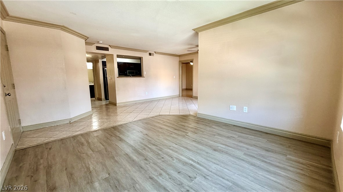 8101 West Flamingo Road, Unit 1082 Las Vegas, NV 89147 - Photo 6 of 23 An inviting open-concept layout connects living areas, featuring a mix of resilient wood-look and tile flooring.