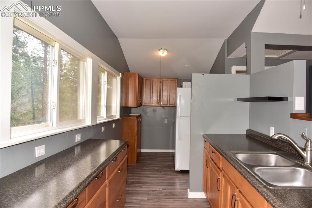 9017 Pine Avenue Beulah, CO 81023 - Photo 14 of 46 a kitchen with granite countertop a sink and a refrigerator