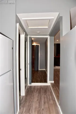 a view of hallway with wooden floor