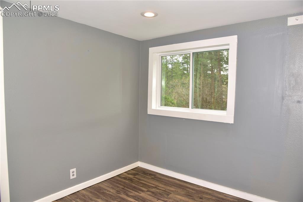 9017 Pine Avenue Beulah, CO 81023 - Photo 22 of 46 a view of an empty room with wooden floor and a window