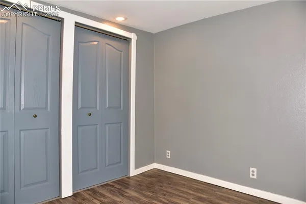 a view of room with wooden floor