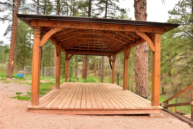 a view of backyard with a small deck and wooden floor