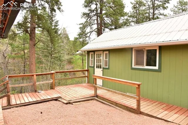 a view of a roof deck with wooden floor and fence