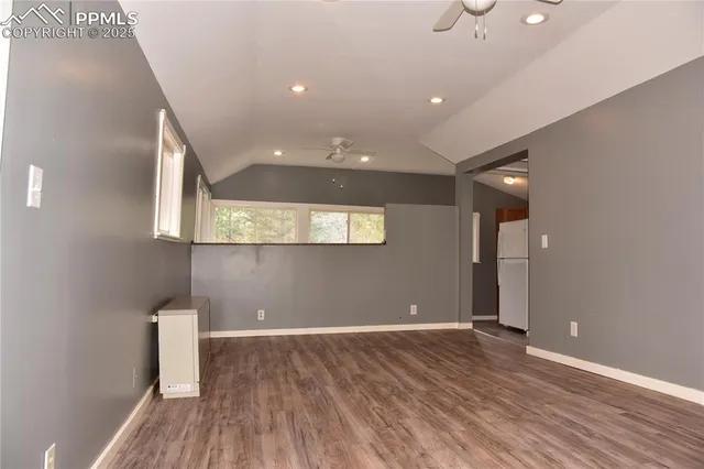 a view of room with window and wooden floor