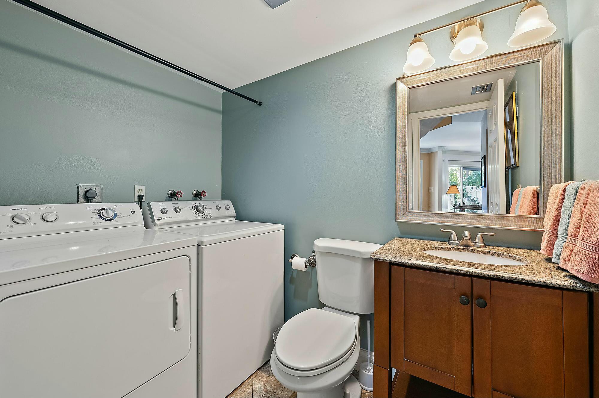 213 Seabreeze Circle Jupiter, FL 33477 - Photo 11 of 38 a bathroom with a toilet sink and mirror