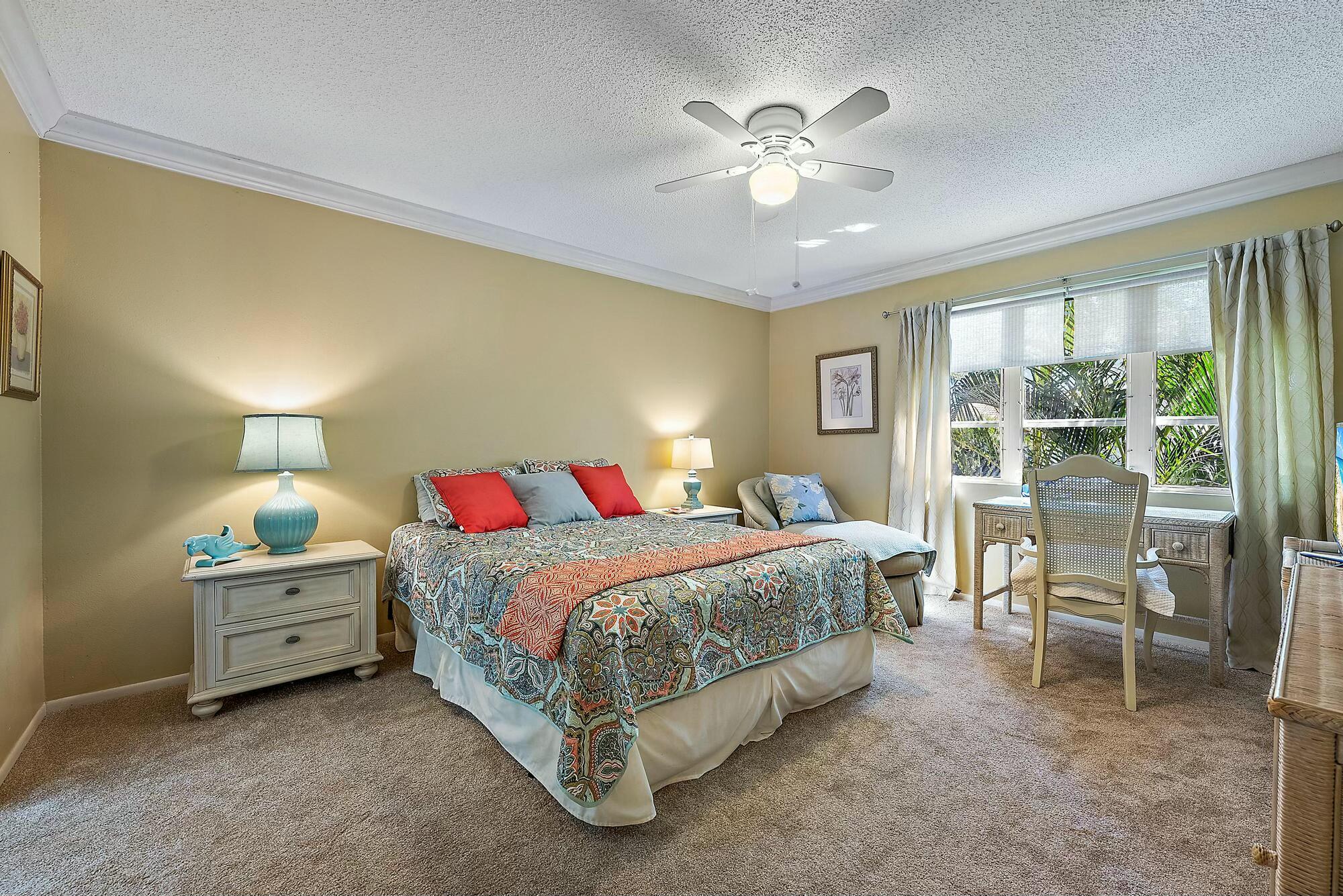 213 Seabreeze Circle Jupiter, FL 33477 - Photo 12 of 38 a bedroom with a bed and a table