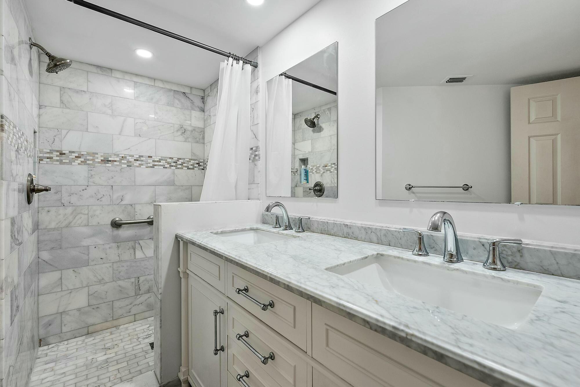213 Seabreeze Circle Jupiter, FL 33477 - Photo 15 of 38 a bathroom with a granite countertop sink a mirror and shower