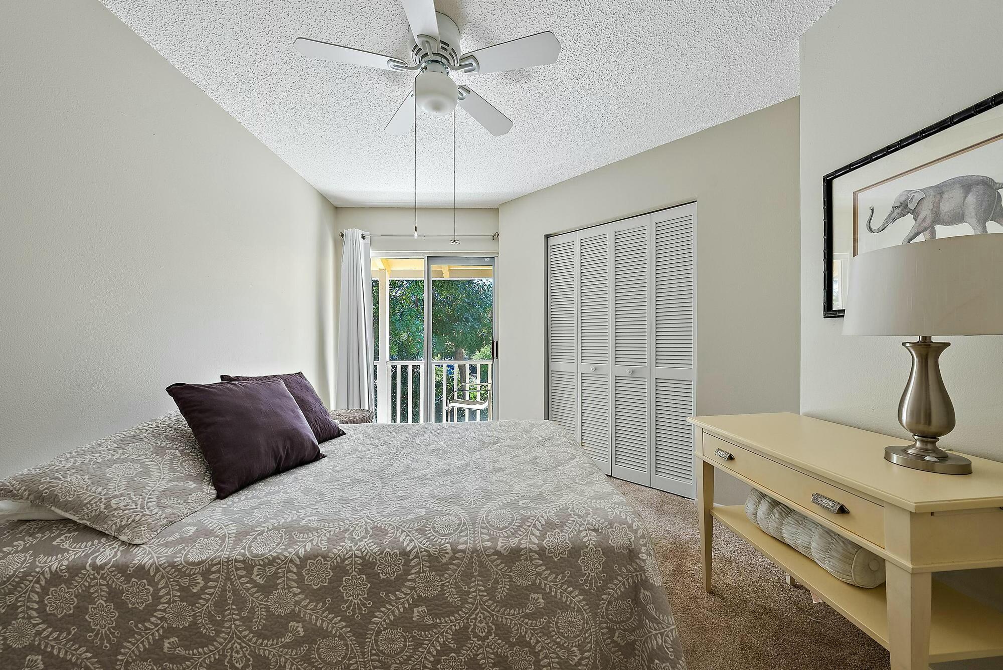 213 Seabreeze Circle Jupiter, FL 33477 - Photo 19 of 38 a bedroom with a bed and window
